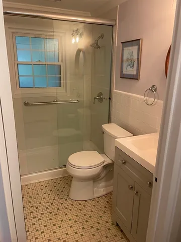 a bathroom with a toilet and a shower