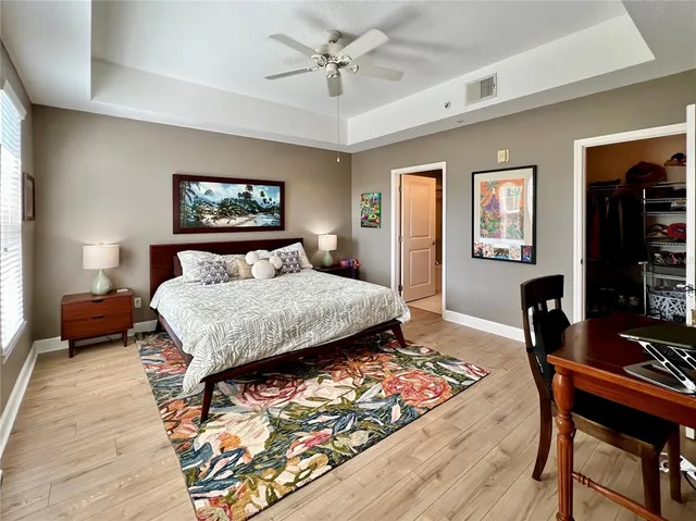 a bedroom with a bed a table and a dresser