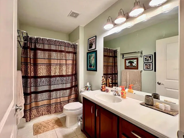 a bathroom with a double vanity sink toilet and shower