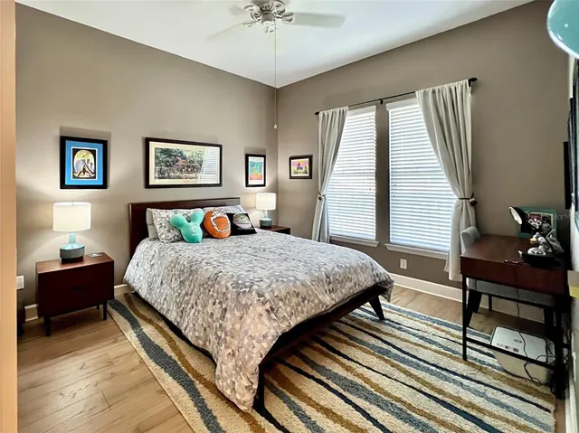 a bedroom with a bed and wooden floor