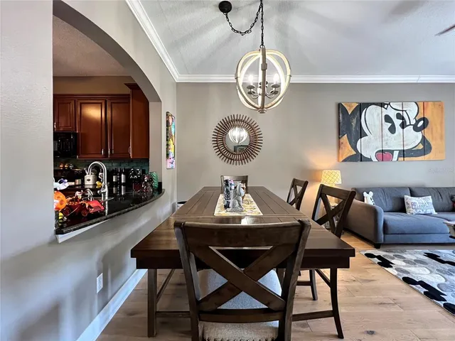 a view of a dining room with furniture and chandelier