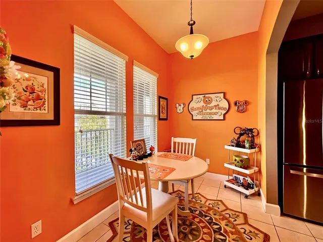 a dining room with furniture and a window