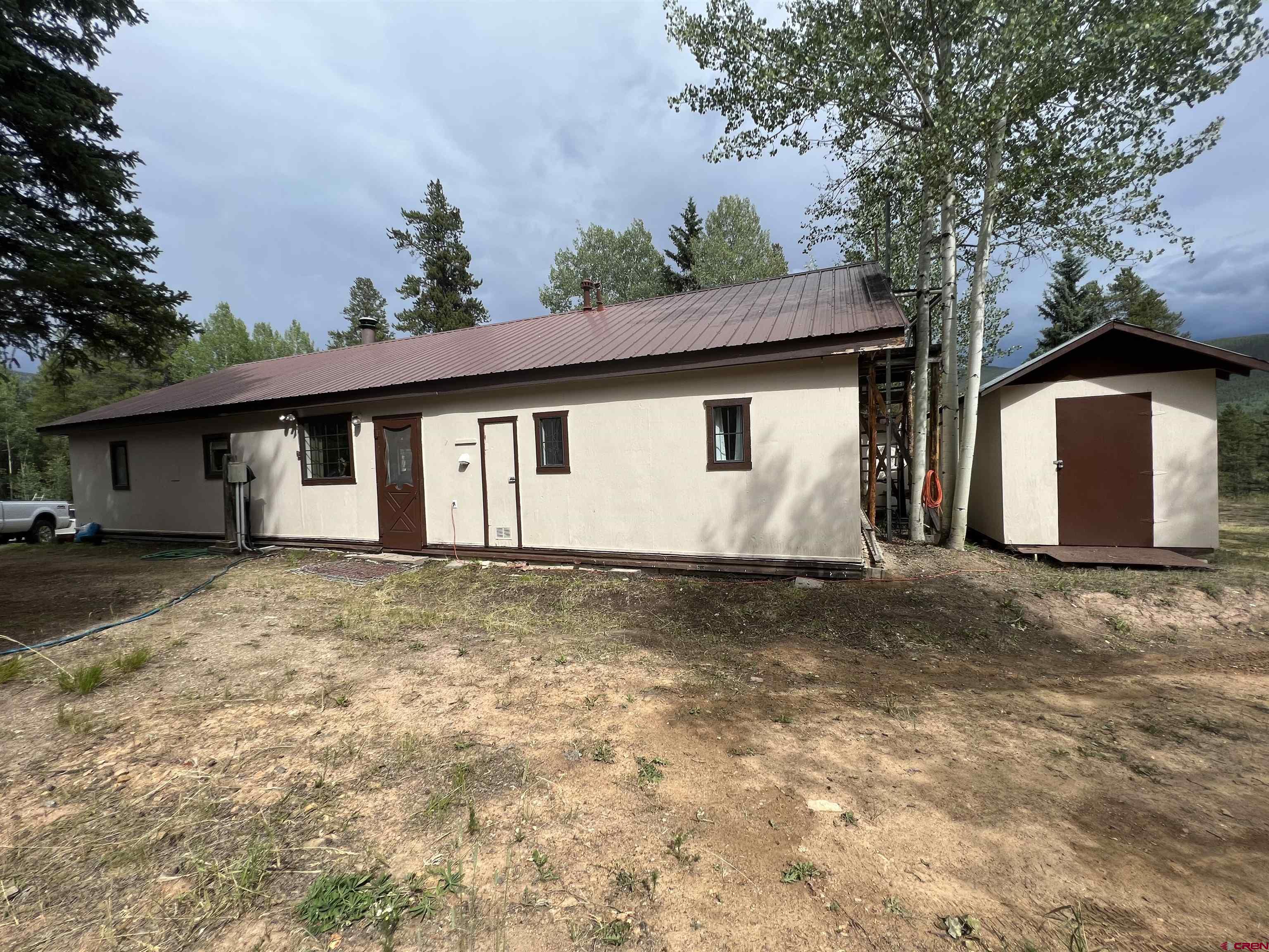 127 Chicago Park Road Pitkin, CO 81241 - Photo 2 of 30 a view of a house with a yard and garage