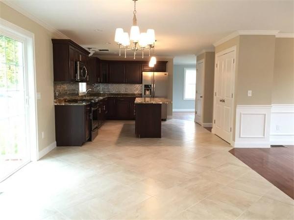 33 Beechnut Road Dracut, MA 01826 - Photo 12 of 30 a large kitchen with a refrigerator a stove top oven a sink and dishwasher