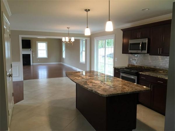 33 Beechnut Road Dracut, MA 01826 - Photo 14 of 30 a kitchen with a center island and a stove