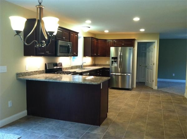 33 Beechnut Road Dracut, MA 01826 - Photo 15 of 30 a kitchen with stainless steel appliances granite countertop a sink and a refrigerator