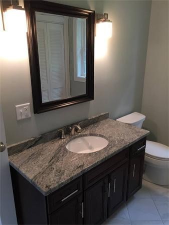 33 Beechnut Road Dracut, MA 01826 - Photo 16 of 30 a bathroom with a granite countertop sink and a mirror