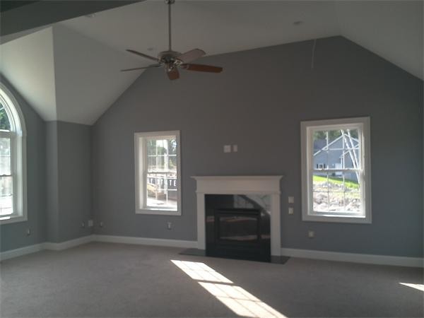 33 Beechnut Road Dracut, MA 01826 - Photo 21 of 30 an empty room with windows fireplace and fan