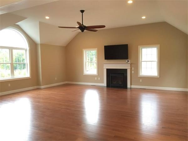 33 Beechnut Road Dracut, MA 01826 - Photo 22 of 30 an empty room with wooden floor a ceiling fan and windows