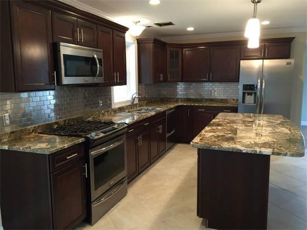 33 Beechnut Road Dracut, MA 01826 - Photo 7 of 30 a kitchen with granite countertop stainless steel appliances and wooden cabinets