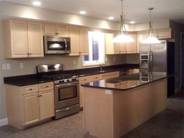 33 Beechnut Road Dracut, MA 01826 - Photo 8 of 30 a kitchen with stainless steel appliances granite countertop a sink a stove and a refrigerator