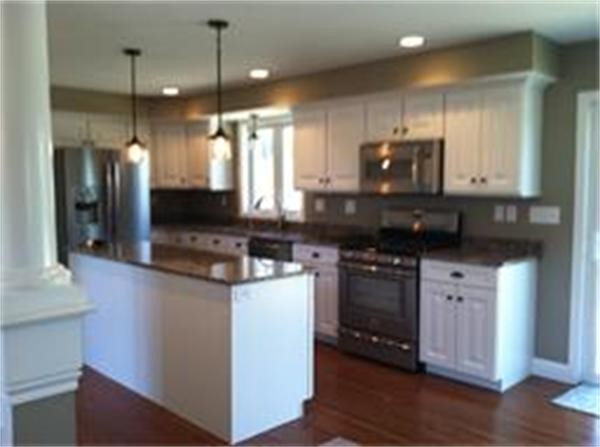 33 Beechnut Road Dracut, MA 01826 - Photo 9 of 30 a kitchen with stainless steel appliances granite countertop a stove a sink and a microwave