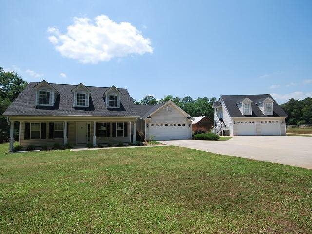 586 Dixon Road Newnan, GA 30263 - Photo 1 of 1 a front view of a house with a garden