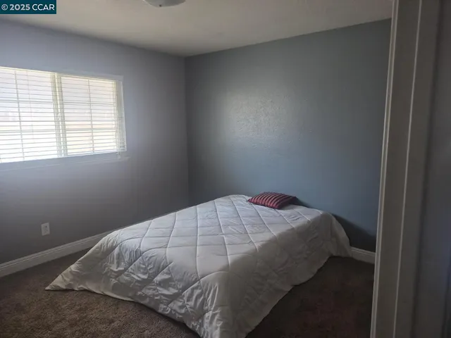 a bedroom with a bed and a night stand