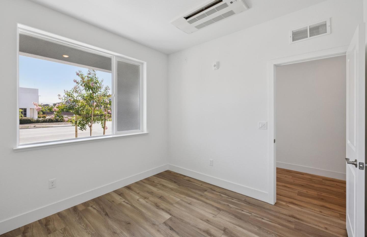 1375 California Circle Milpitas, CA 95035 - Photo 12 of 47 a view of a room that has wooden floor and a window