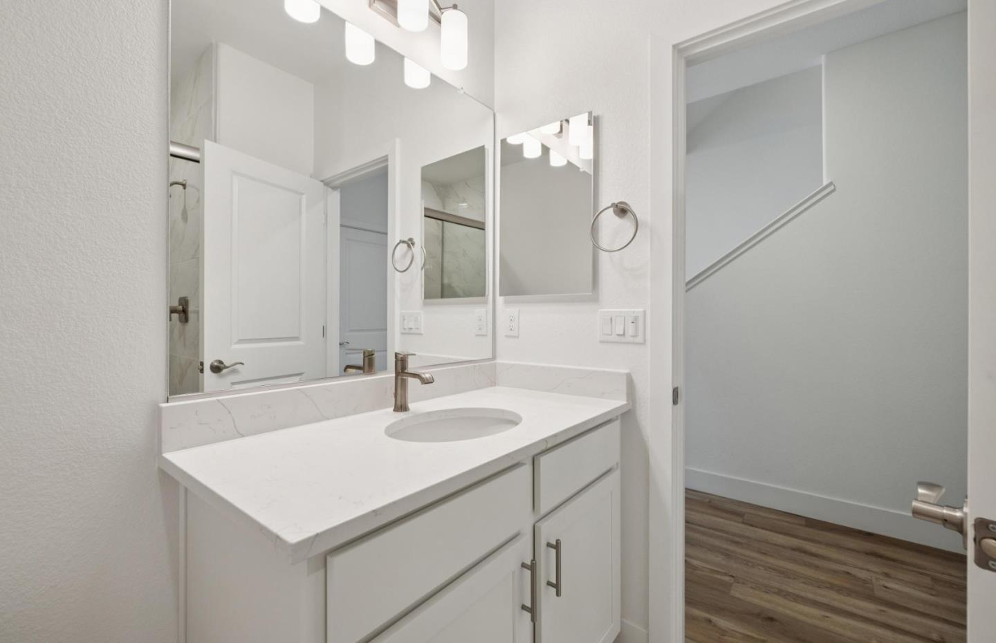 1375 California Circle Milpitas, CA 95035 - Photo 16 of 47 a bathroom with a sink a light fixture and a mirror