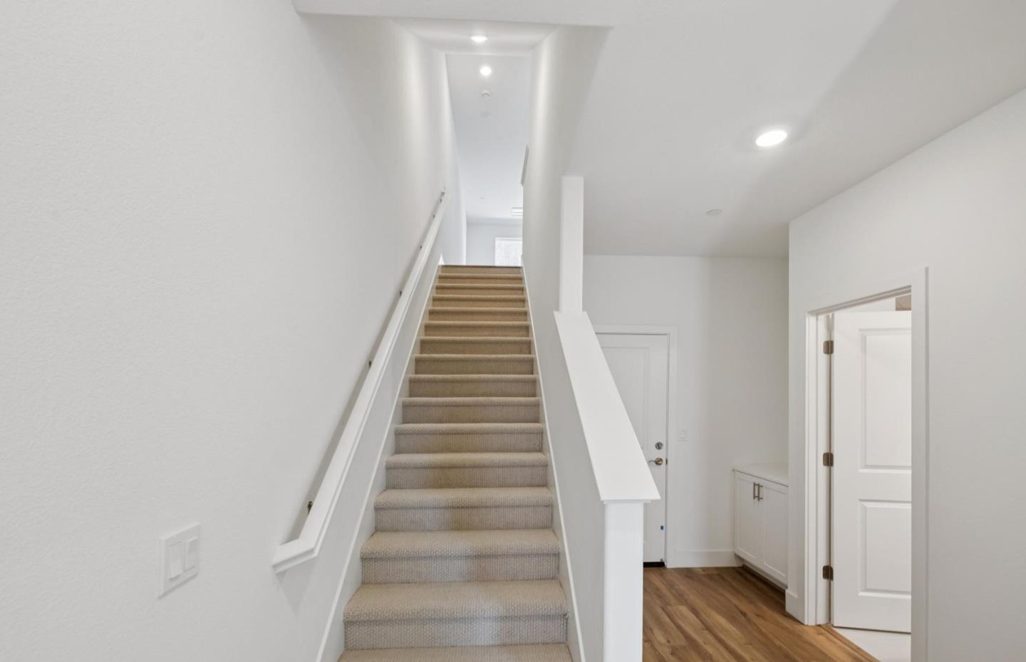 1375 California Circle Milpitas, CA 95035 - Photo 18 of 47 a view of staircase with wooden floor and white walls