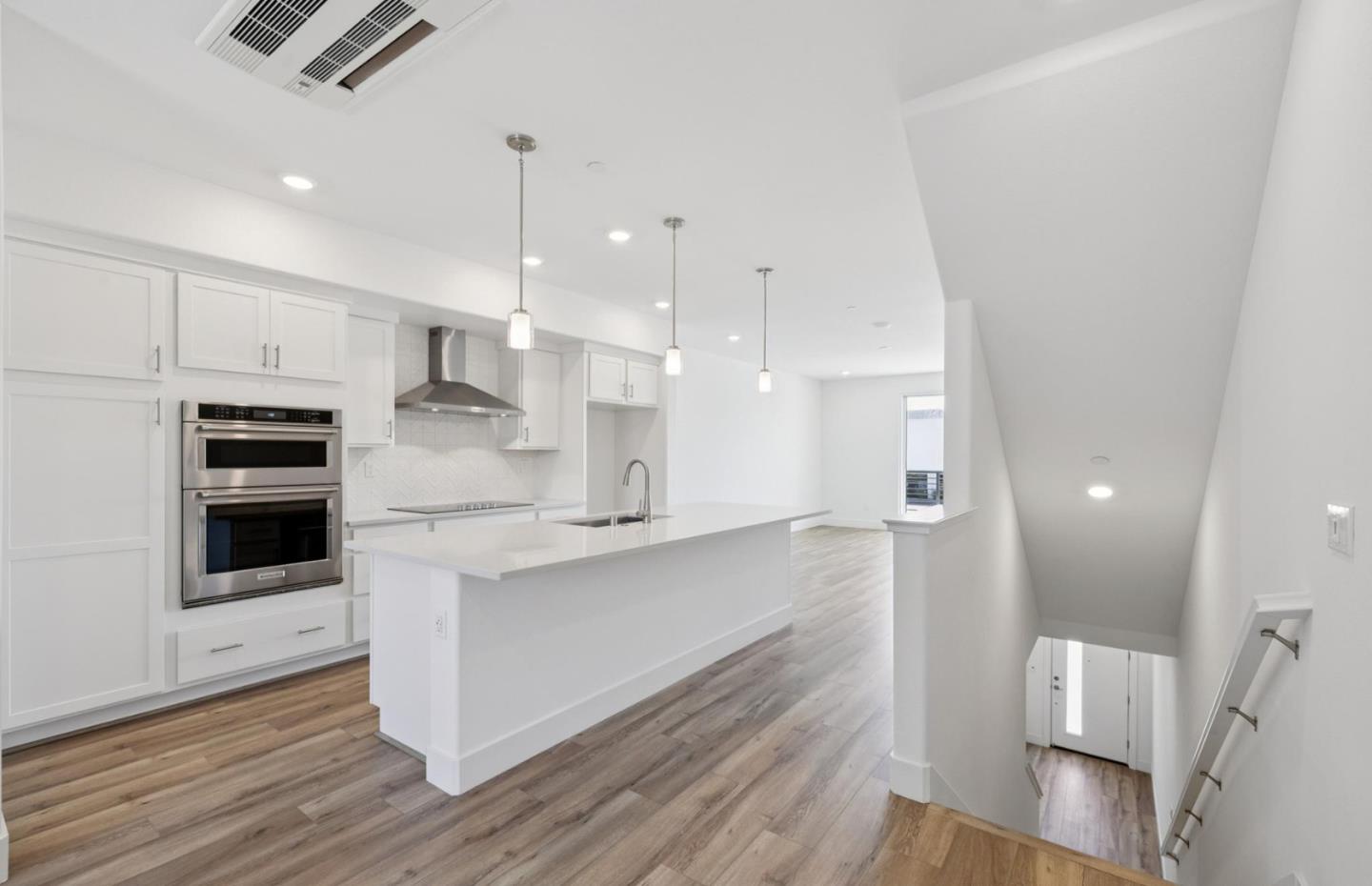 1375 California Circle Milpitas, CA 95035 - Photo 20 of 47 a kitchen with stainless steel appliances kitchen island granite countertop a stove a sink and a refrigerator