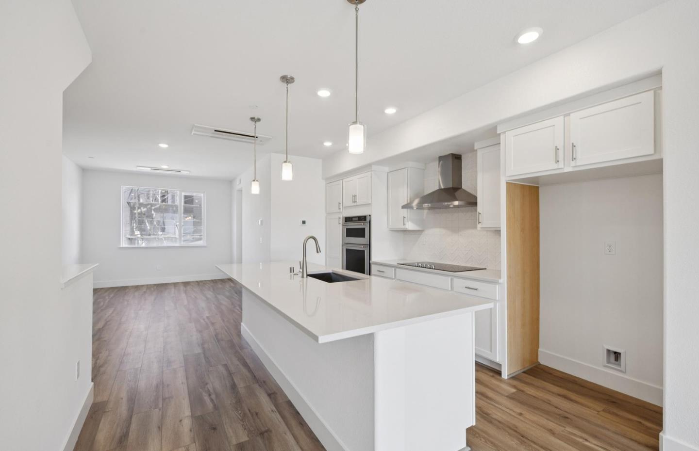 1375 California Circle Milpitas, CA 95035 - Photo 22 of 47 a kitchen with kitchen island a counter top space a sink and appliances