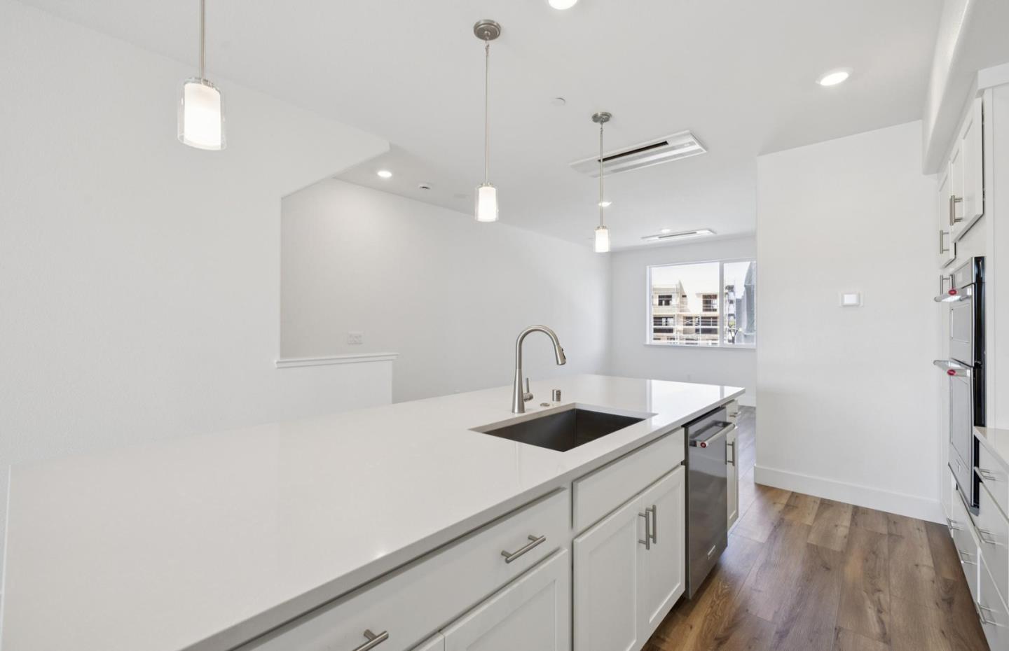 1375 California Circle Milpitas, CA 95035 - Photo 23 of 47 a kitchen with a sink dishwasher and a refrigerator with wooden floor