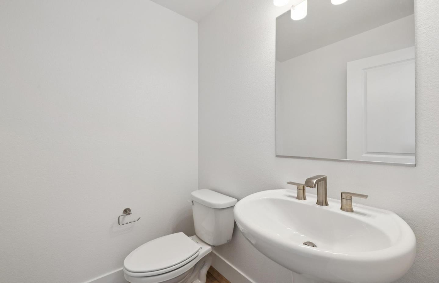 1375 California Circle Milpitas, CA 95035 - Photo 32 of 47 a bathroom with a sink a toilet and mirror