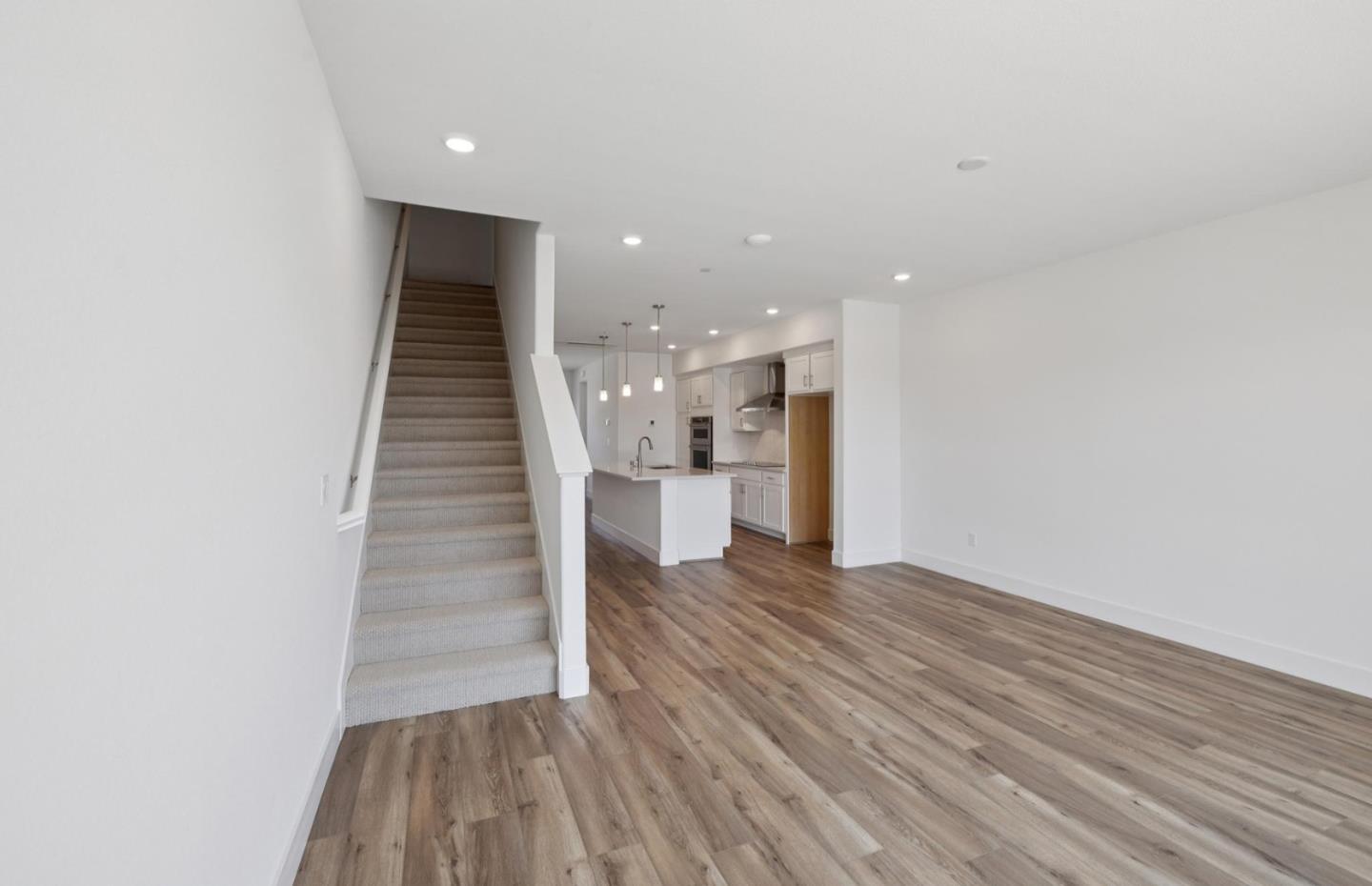 1375 California Circle Milpitas, CA 95035 - Photo 41 of 47 a view of a hallway with wooden floor and staircase