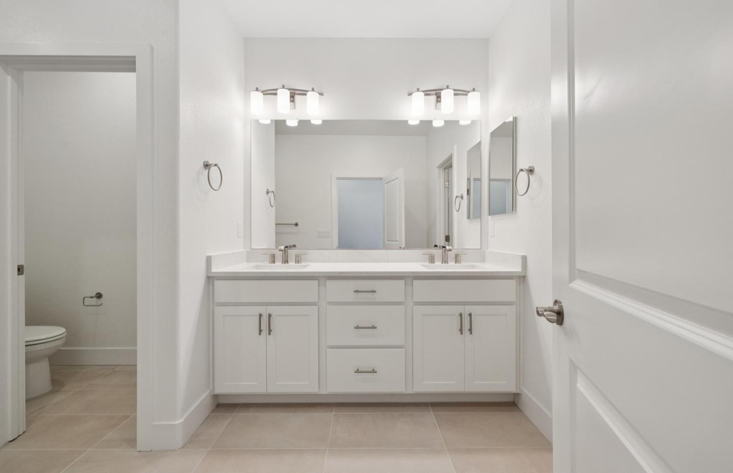 1375 California Circle Milpitas, CA 95035 - Photo 45 of 47 a bathroom with a double vanity sink and a mirror