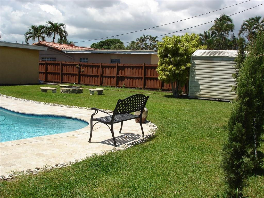 4225 Jackson Street Hollywood, FL 33021 - Photo 12 of 25 a view of a bench in the garden near a lake
