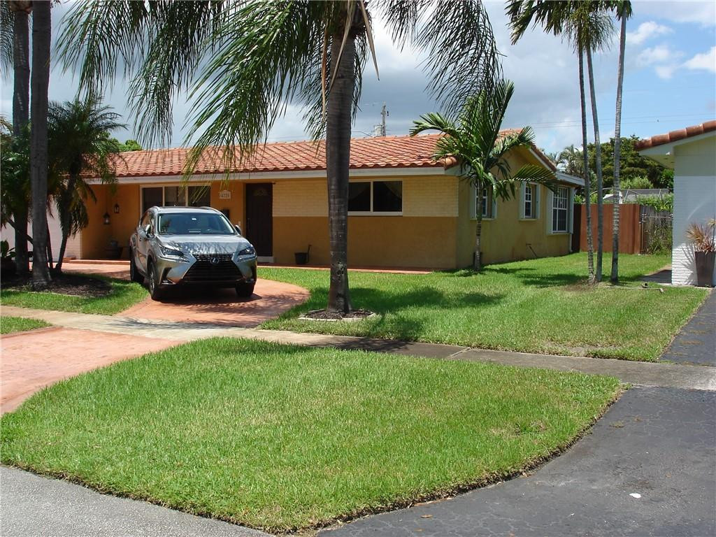 4225 Jackson Street Hollywood, FL 33021 - Photo 14 of 25 a front view of a house with garden