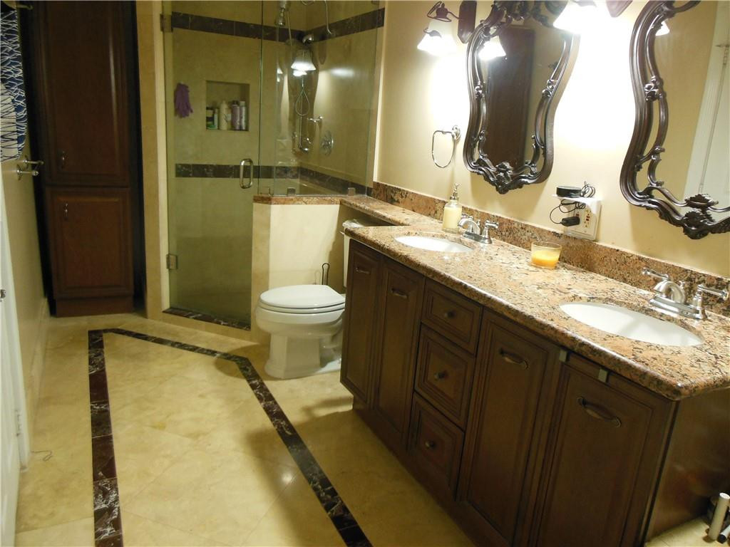 4225 Jackson Street Hollywood, FL 33021 - Photo 16 of 25 a bathroom with a granite countertop sink toilet and shower