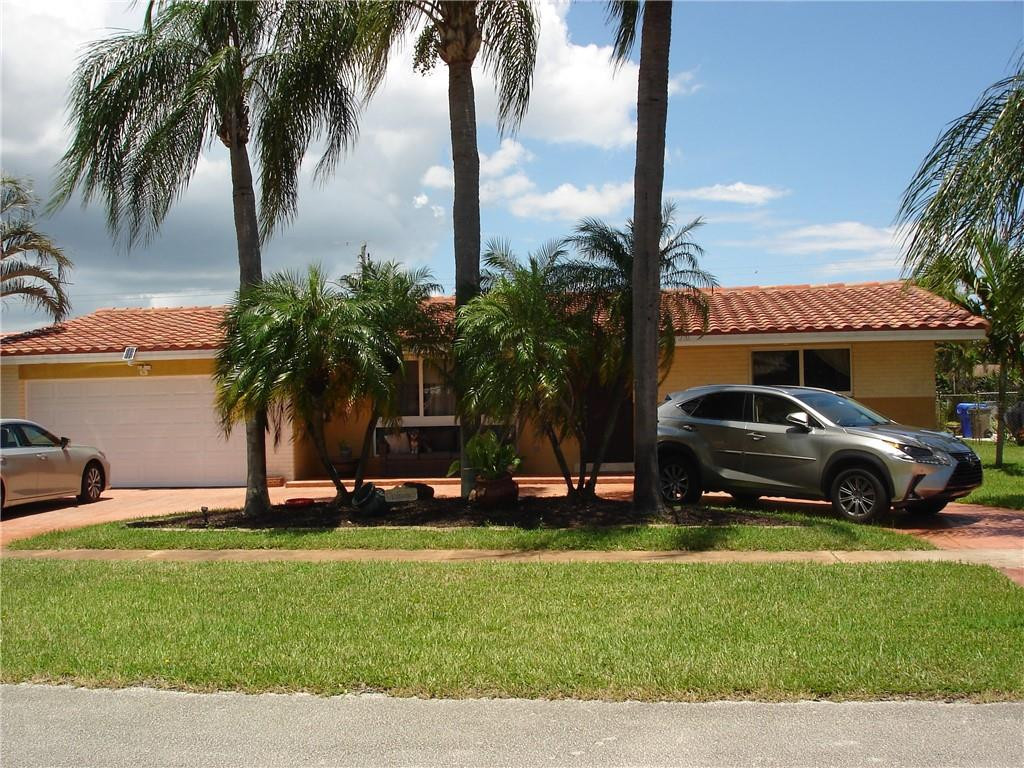 4225 Jackson Street Hollywood, FL 33021 - Photo 2 of 25 a car parked in front of a house with a yard