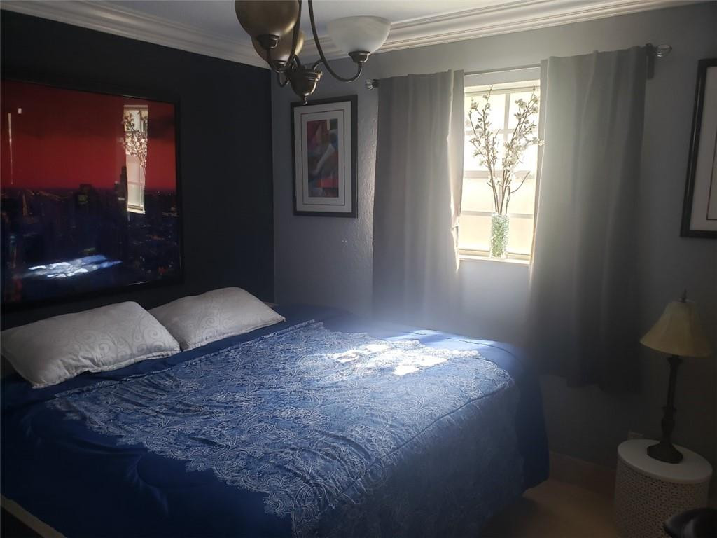 4225 Jackson Street Hollywood, FL 33021 - Photo 22 of 25 a bedroom with a bed and a lamp on the dresser
