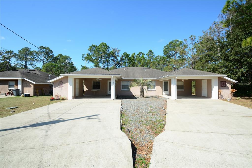 4 Wheeler Place, Unit A Palm Coast, FL 32164 - Photo 1 of 19 a house with trees in the background