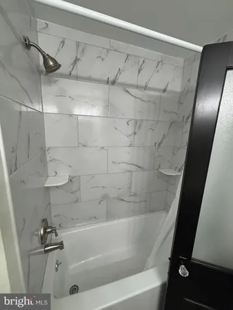 a bathroom with a sink a toilet a mirror and shower curtain