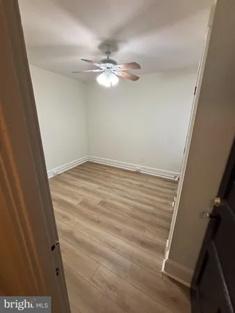 a view of a hallway with wooden floor and stairs