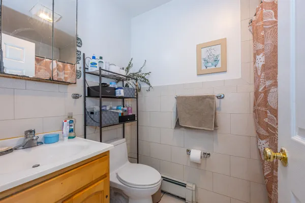 a bathroom with a sink a toilet and shower curtain