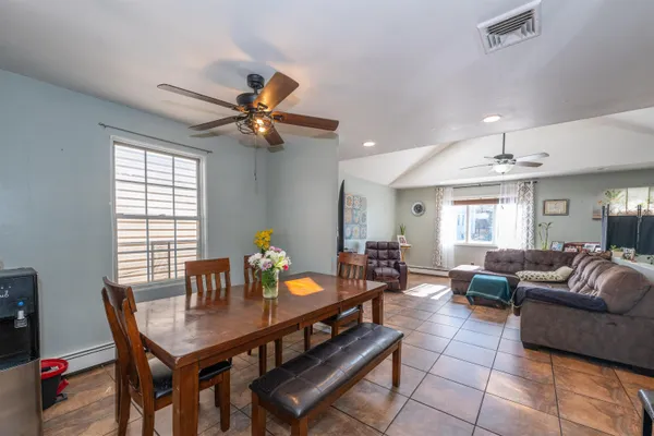 a living room with furniture a chandelier and a table