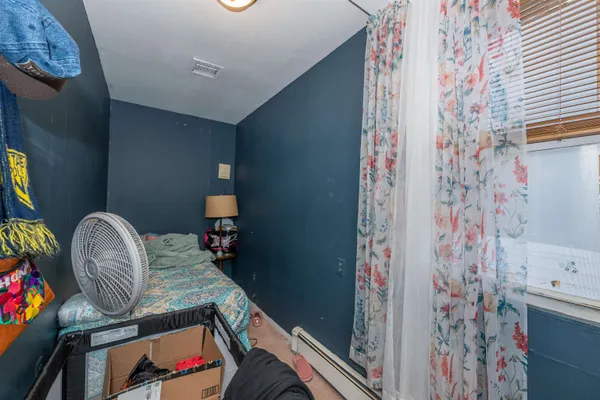 a living room with furniture and a lamp