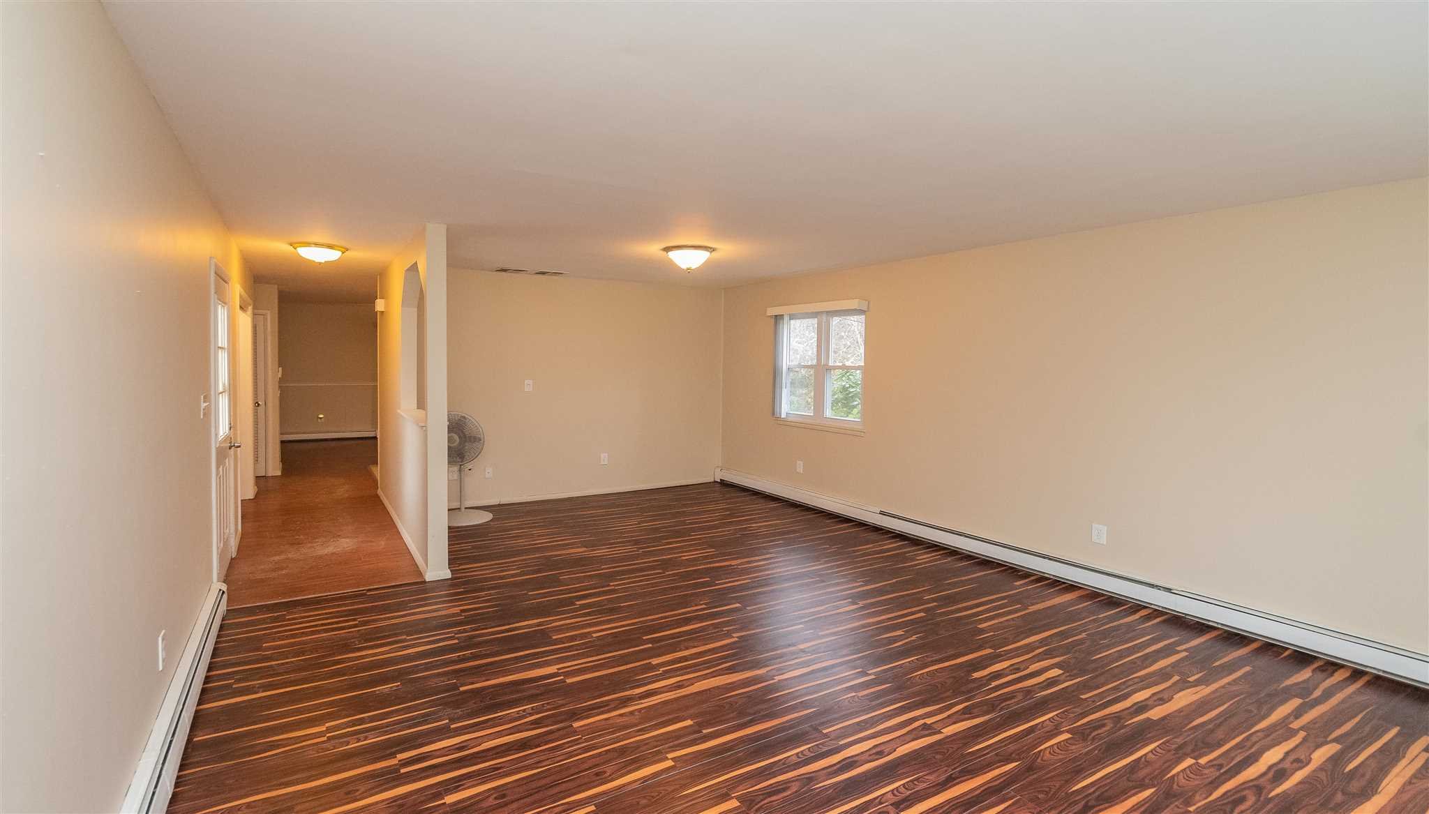 6 McGrath Terrace Fishkill, NY 12524 - Photo 12 of 38 a view of an empty room with wooden floor and a window