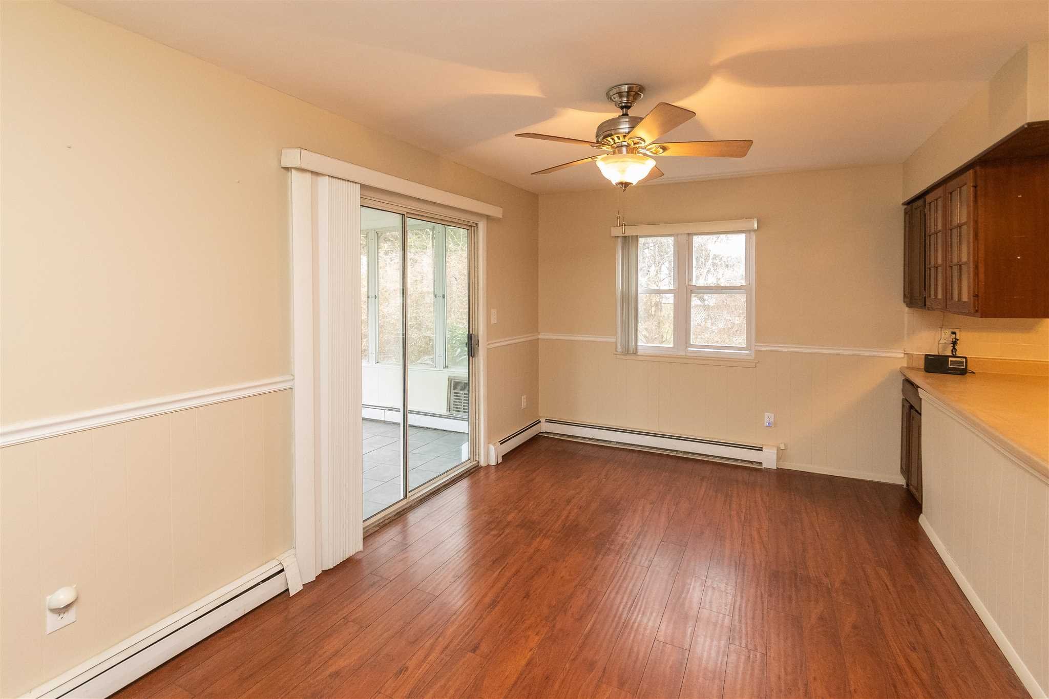 6 McGrath Terrace Fishkill, NY 12524 - Photo 13 of 38 an empty room with wooden floor fan and windows