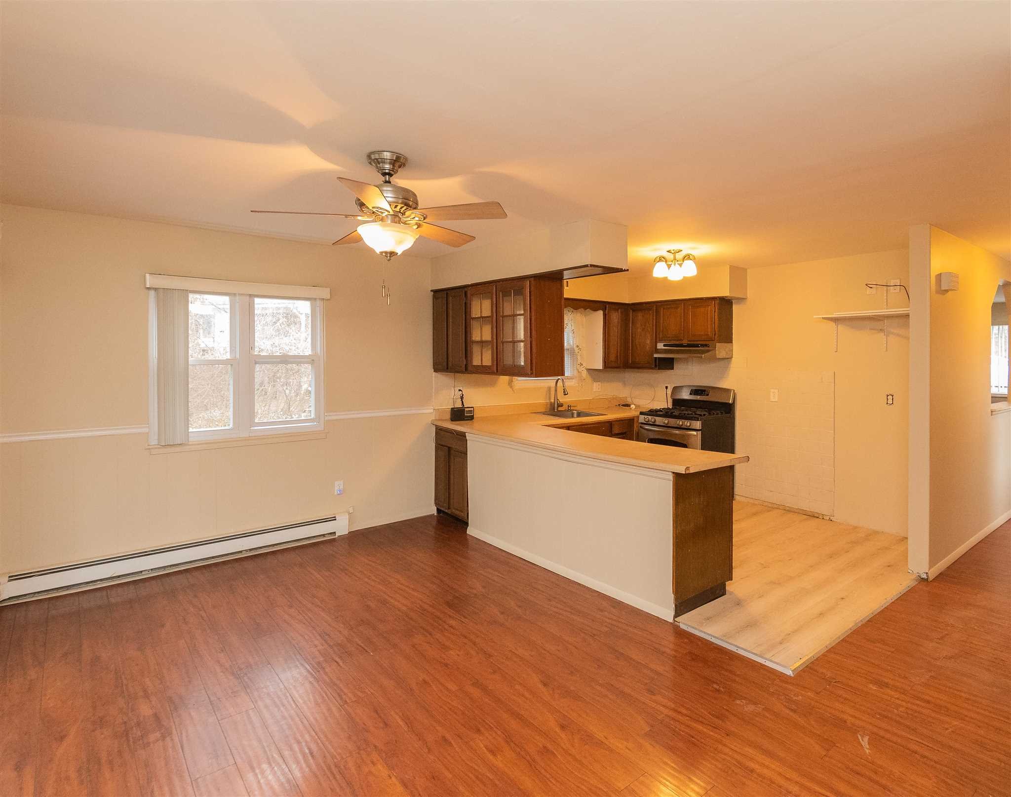 6 McGrath Terrace Fishkill, NY 12524 - Photo 14 of 38 a kitchen with granite countertop a stove cabinets and wooden floor