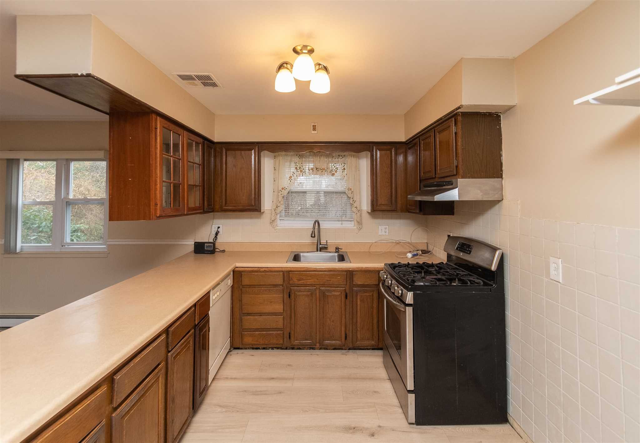 6 McGrath Terrace Fishkill, NY 12524 - Photo 21 of 38 a kitchen with a sink dishwasher a stove and a refrigerator