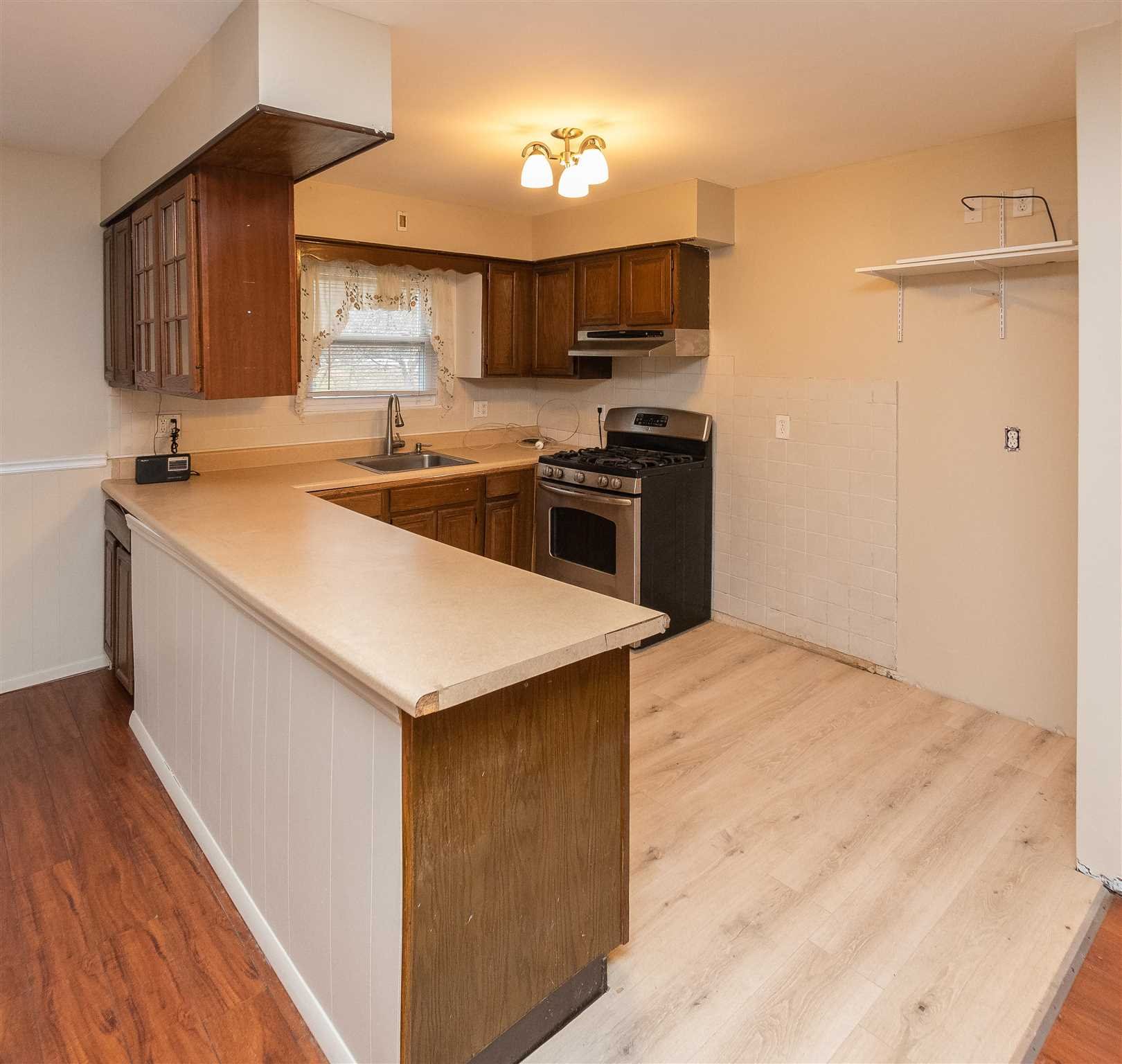 6 McGrath Terrace Fishkill, NY 12524 - Photo 22 of 38 a kitchen with a stove a sink and a refrigerator