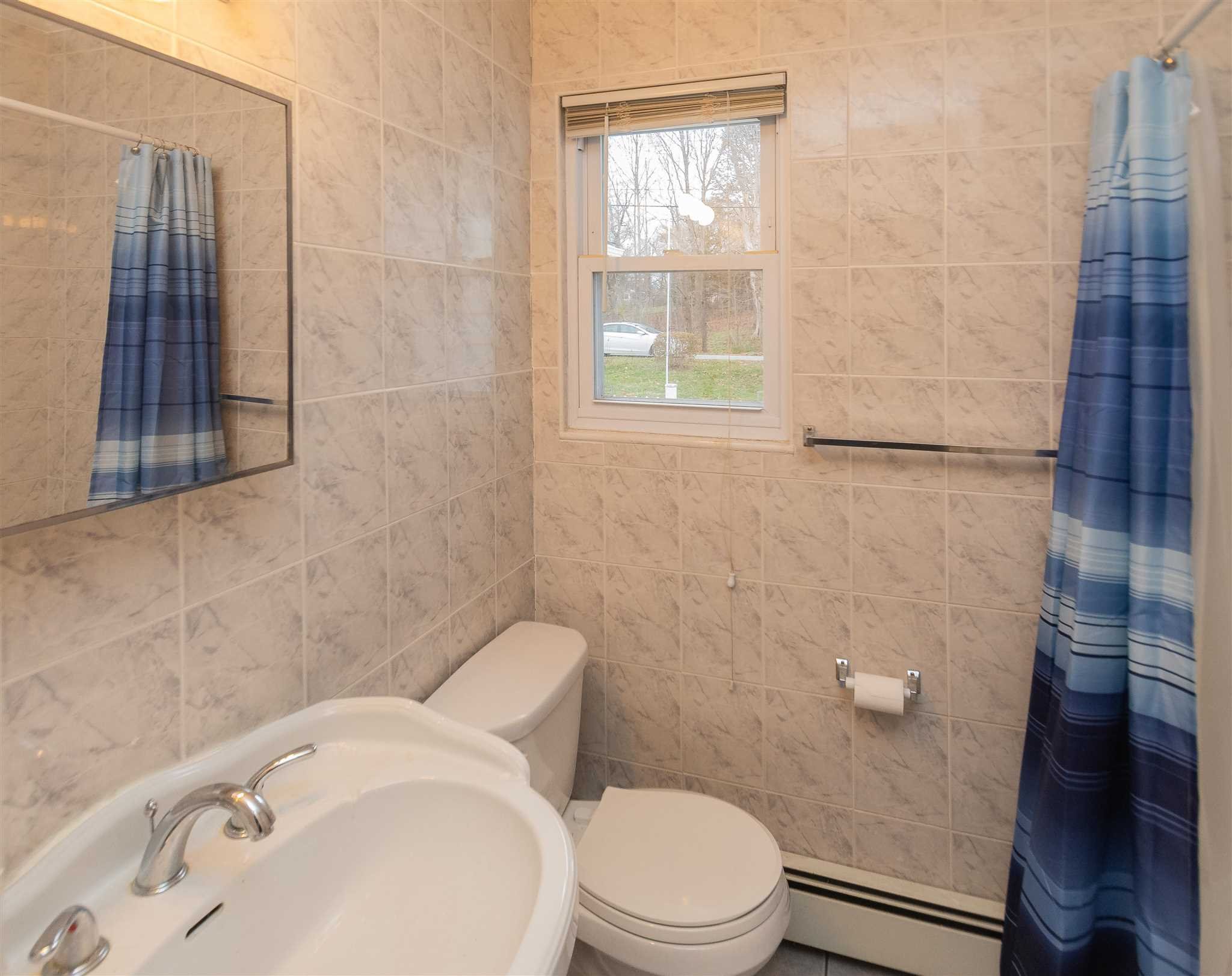 6 McGrath Terrace Fishkill, NY 12524 - Photo 24 of 38 a white toilet sitting next to a bathroom sink and tub