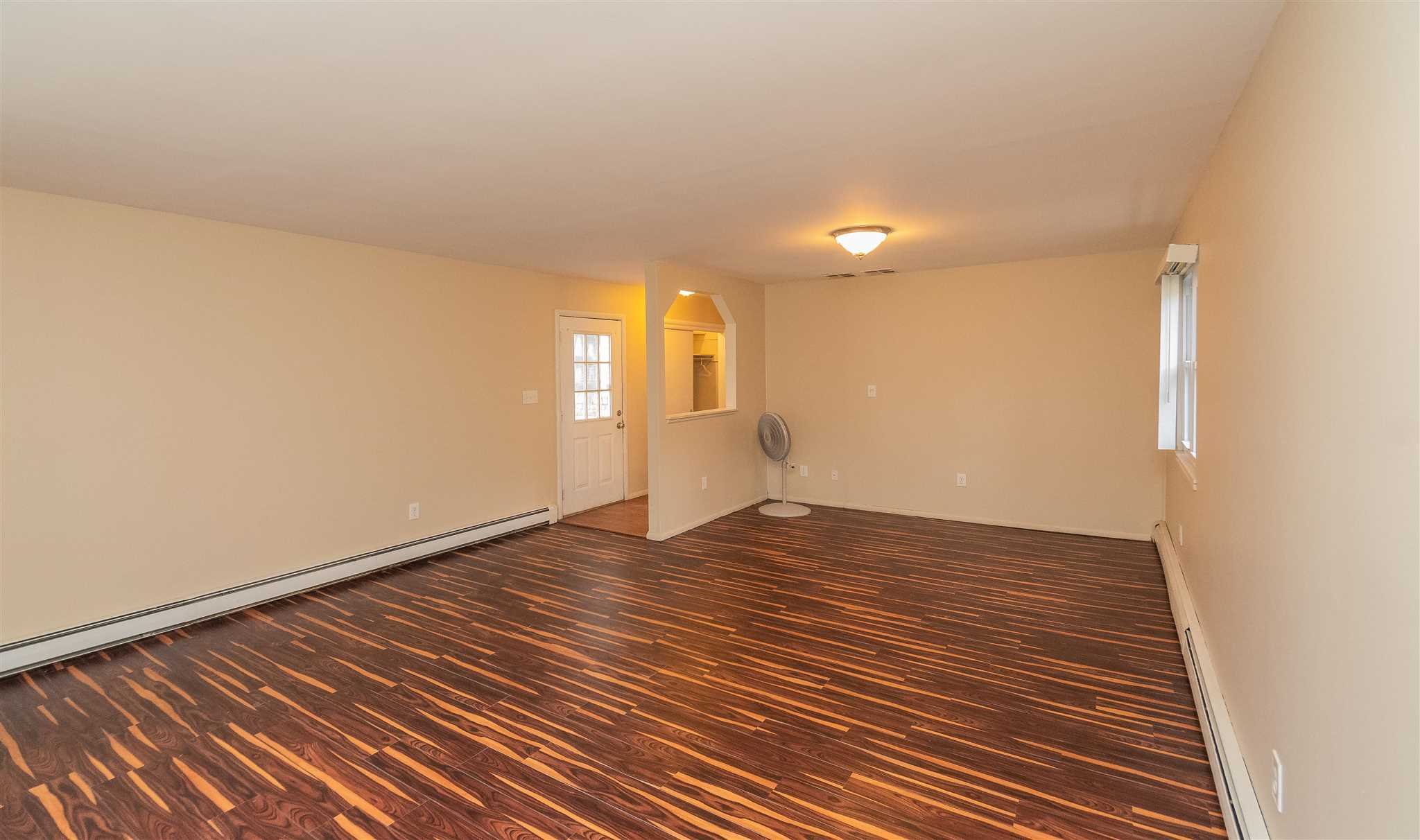 6 McGrath Terrace Fishkill, NY 12524 - Photo 33 of 38 a view of an empty room with wooden floor and a window