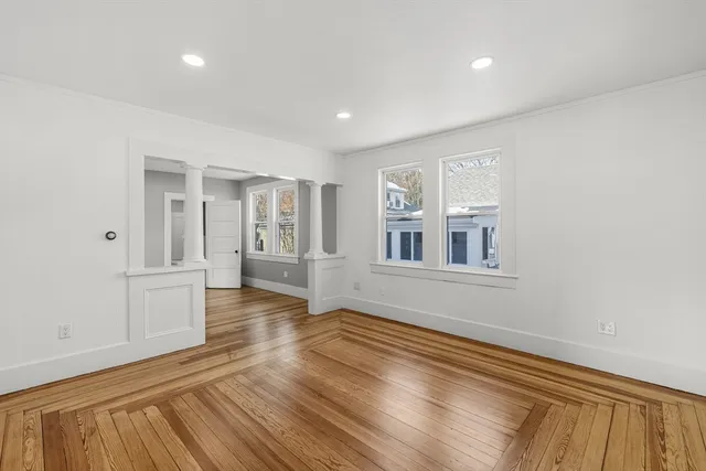 wooden floor in an empty room with a window