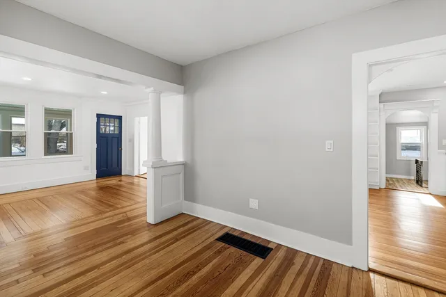 wooden floor in an empty room with a window