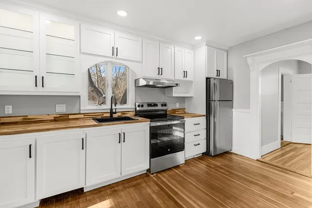 a kitchen with stainless steel appliances granite countertop a refrigerator sink and cabinets
