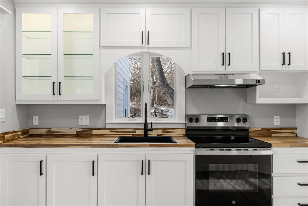 2 Oakdale Street Wareham, MA 02571 - Photo 25 of 33 a kitchen with stainless steel appliances granite countertop a stove and a white cabinets