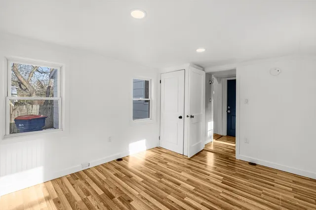 a view of wooden floor and windows in a room